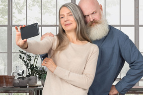 Elderly couple taking selfie on phone