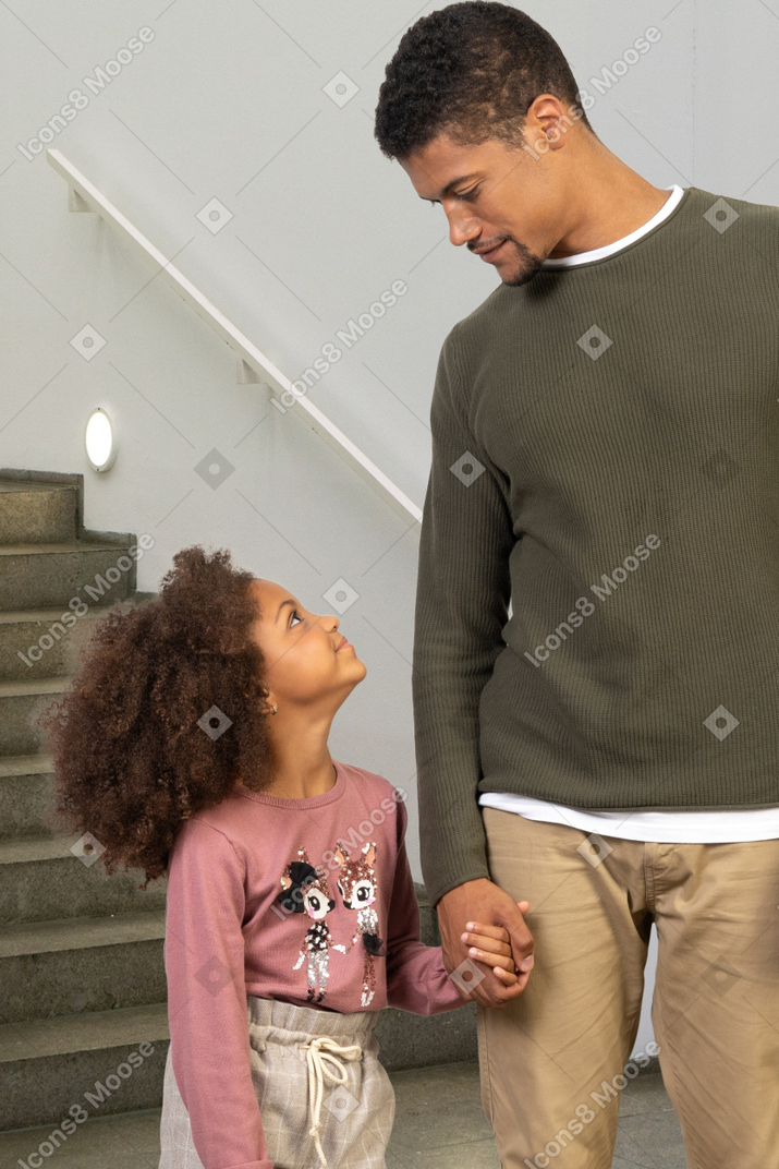 A man holding a girl's hand