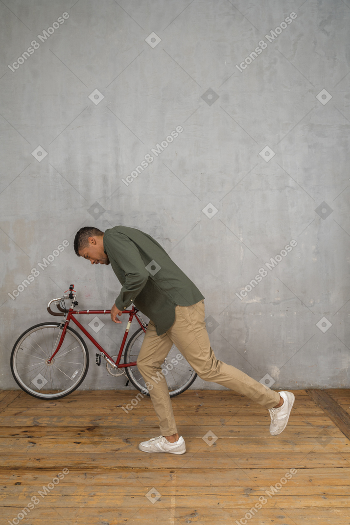 Side view of a man tripping and almost falling forward