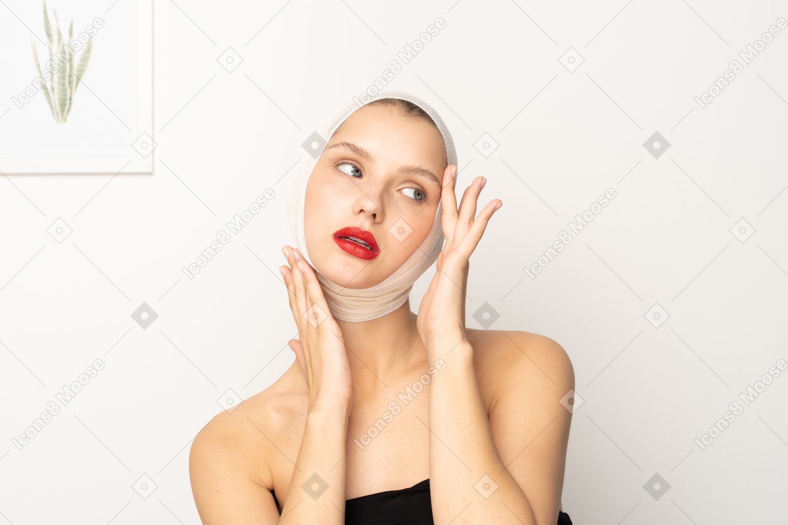 Woman with head bandage touching her face