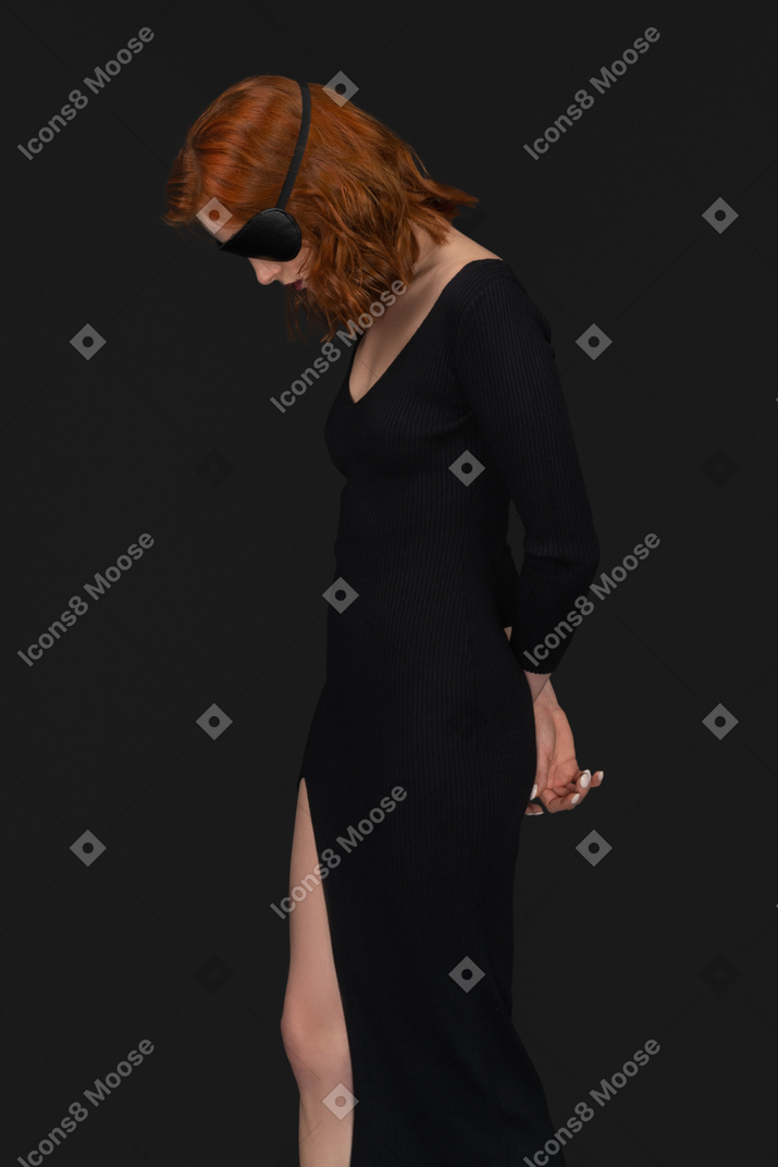 A side view of the cute girl dressed in black and looking down