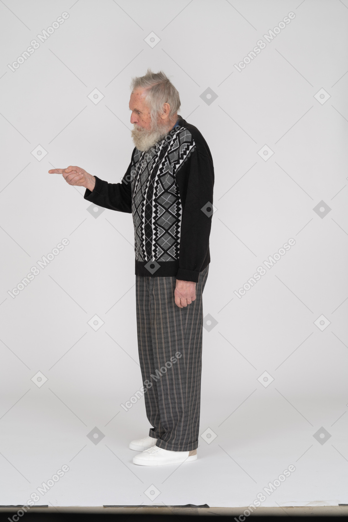 Side view of old man pointing with finger