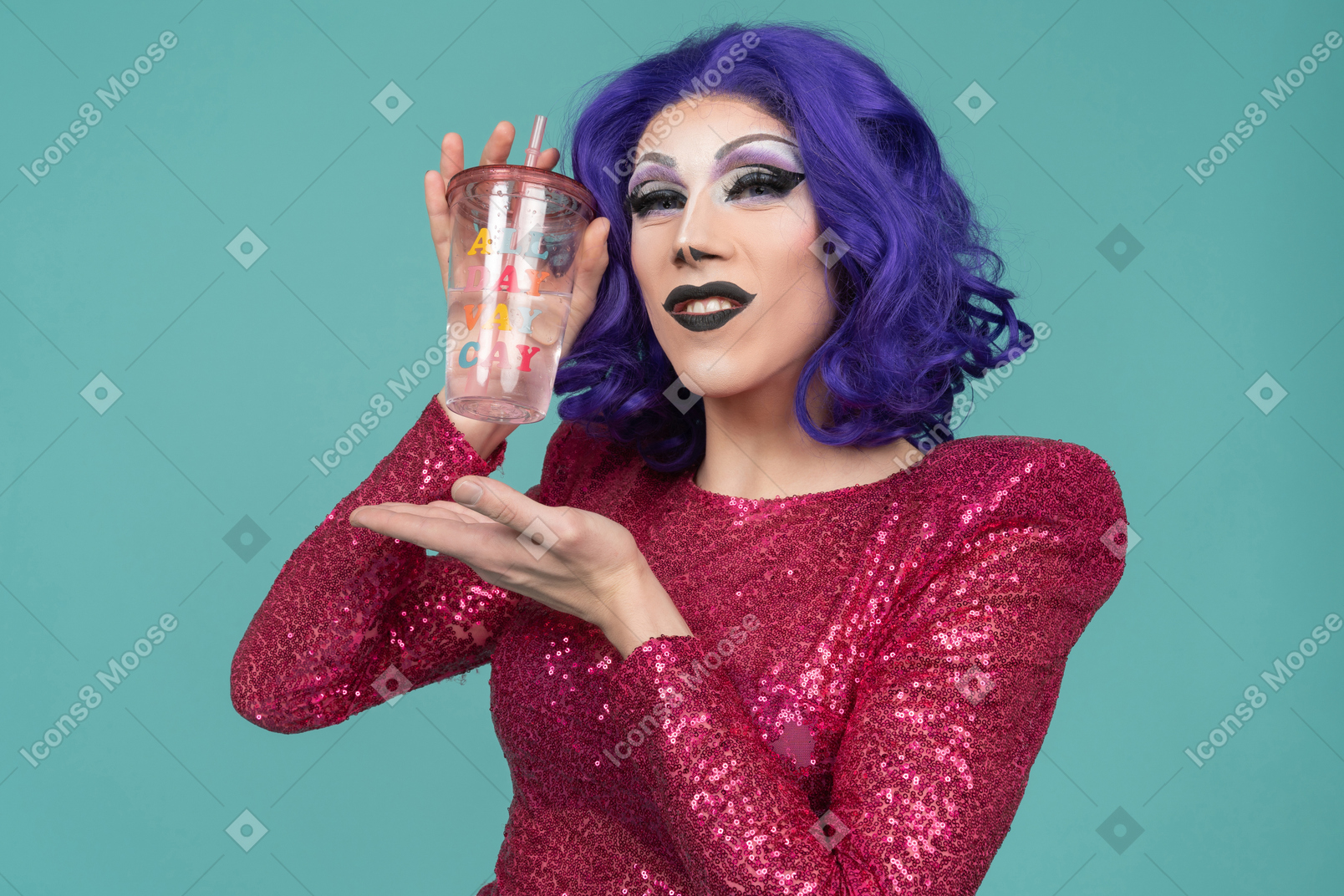 Portrait of a drag queen in pink dress smiling while showing off plastic cup