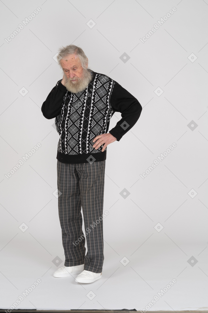 Old man standing and looking down