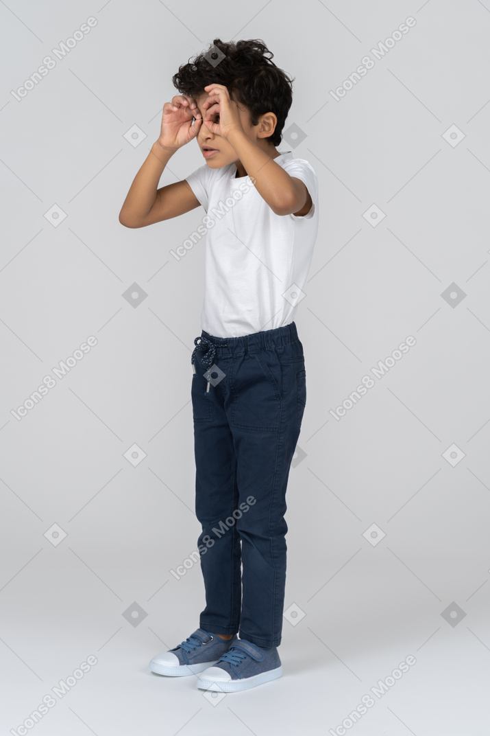 A boy looking through imaginable binoculars