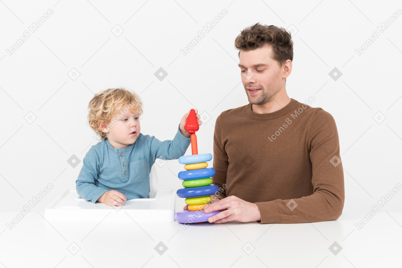 Father and son assembling a stacking toy