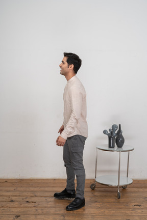 Man in casual clothes standing in profile