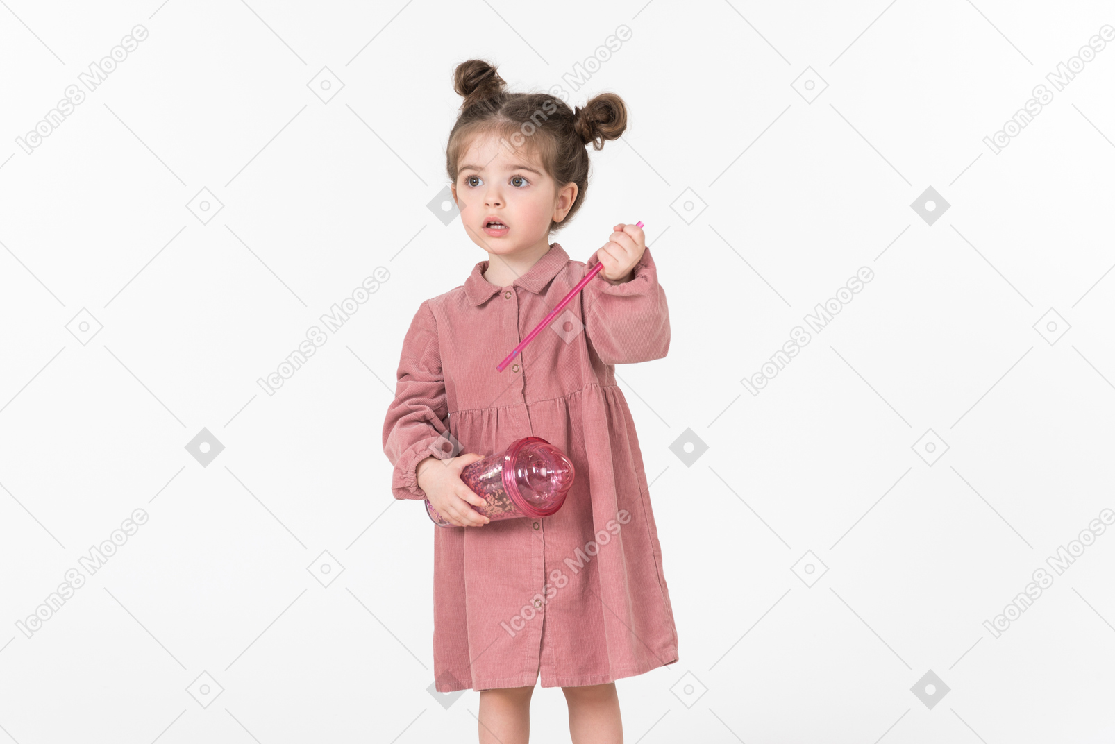 Little kid girl holding pink plastic cup and straw