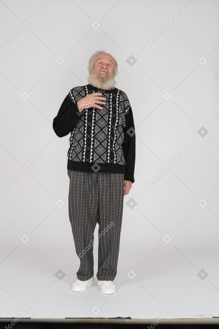 Old man talking and looking up with hand on chest