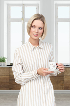 A woman in a striped shirt holding a cup