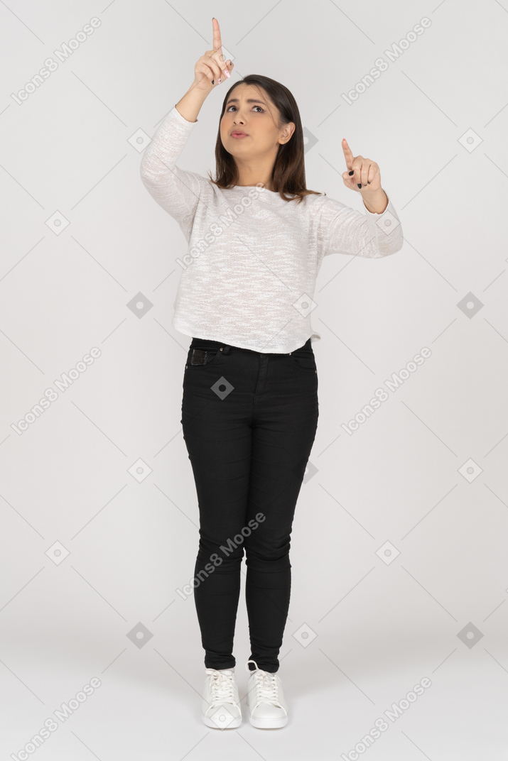 Front view of a young indian female in casual clothes choosing something