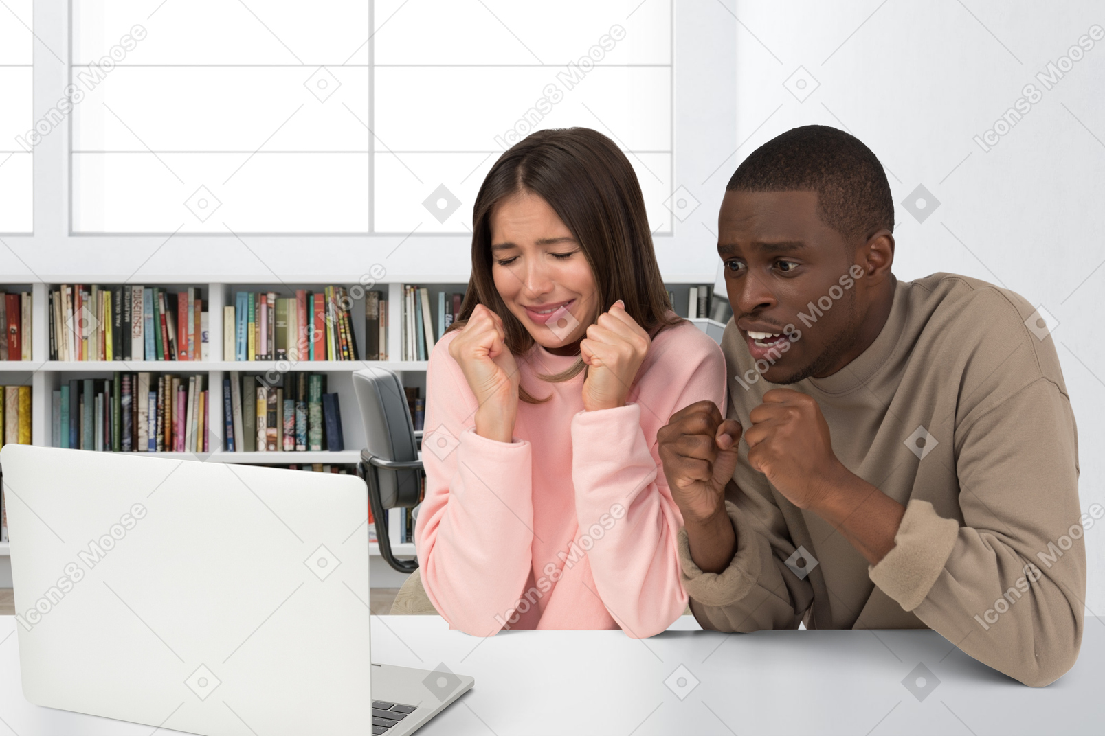 A scared man and a scared woman looking at a laptop