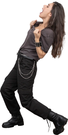 Side view of a shouting female rocker tearing up her t-shirt
