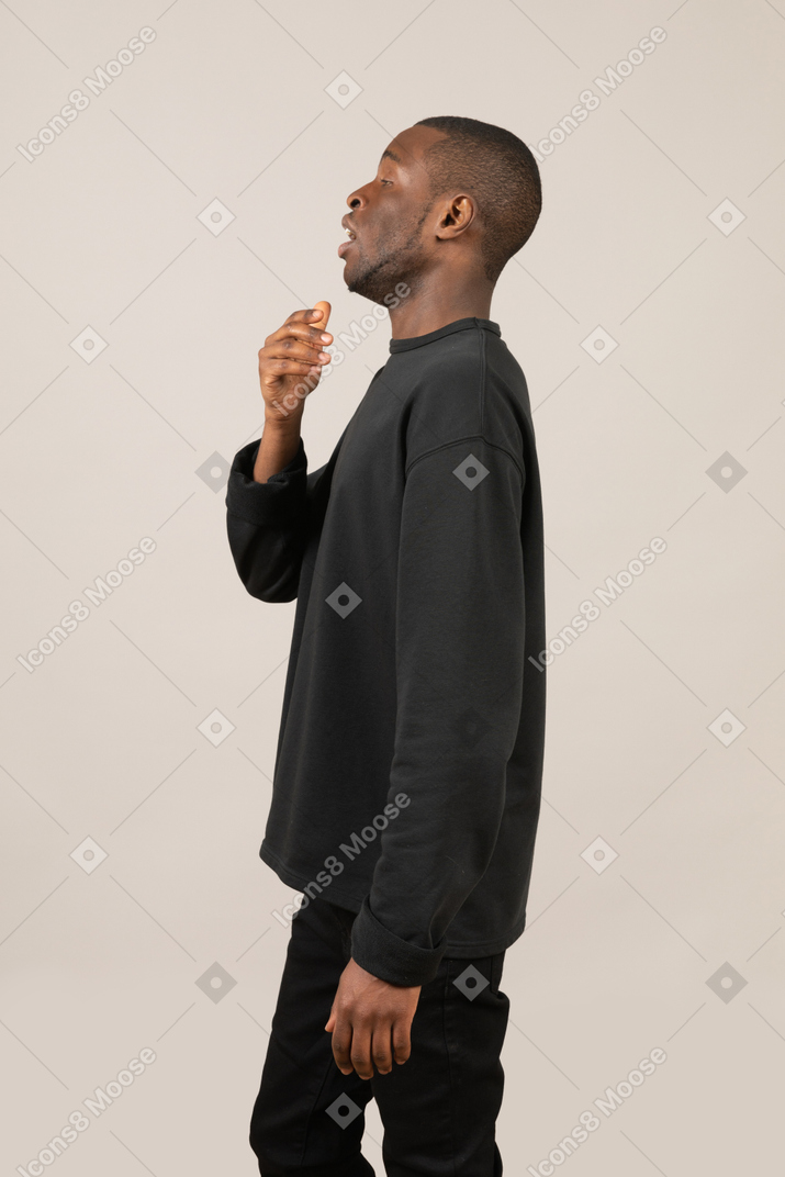 Side view of a man sneezing