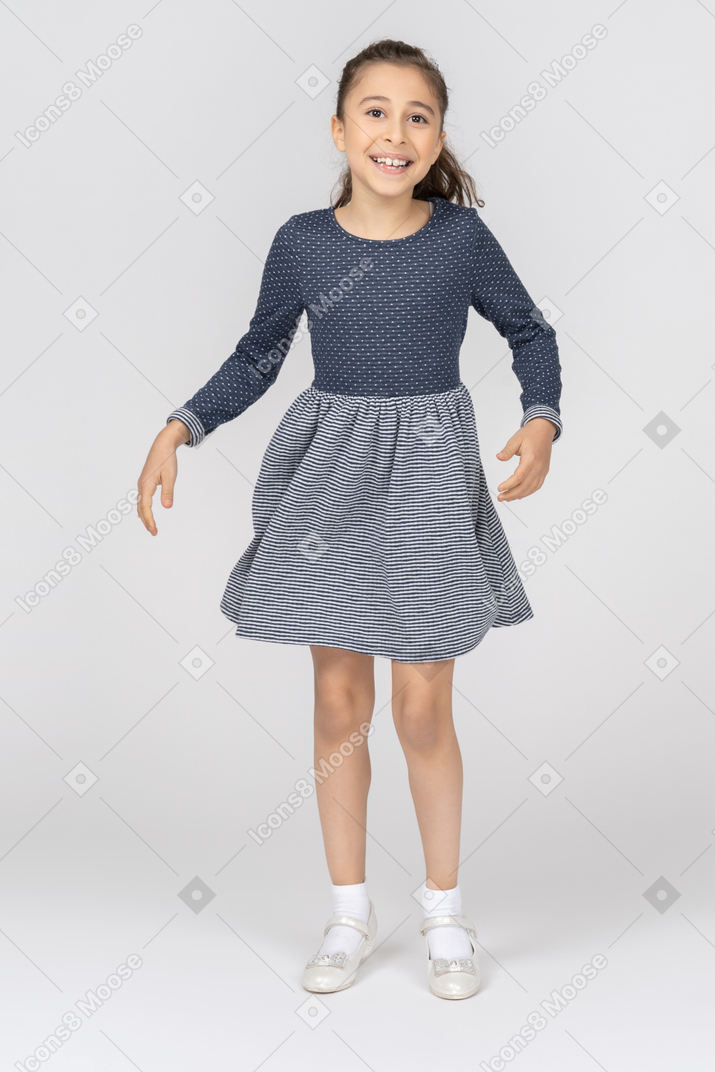 Front view of a girl dancing and jumping happily