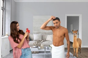 Young woman taking photo of young man and llama in living room