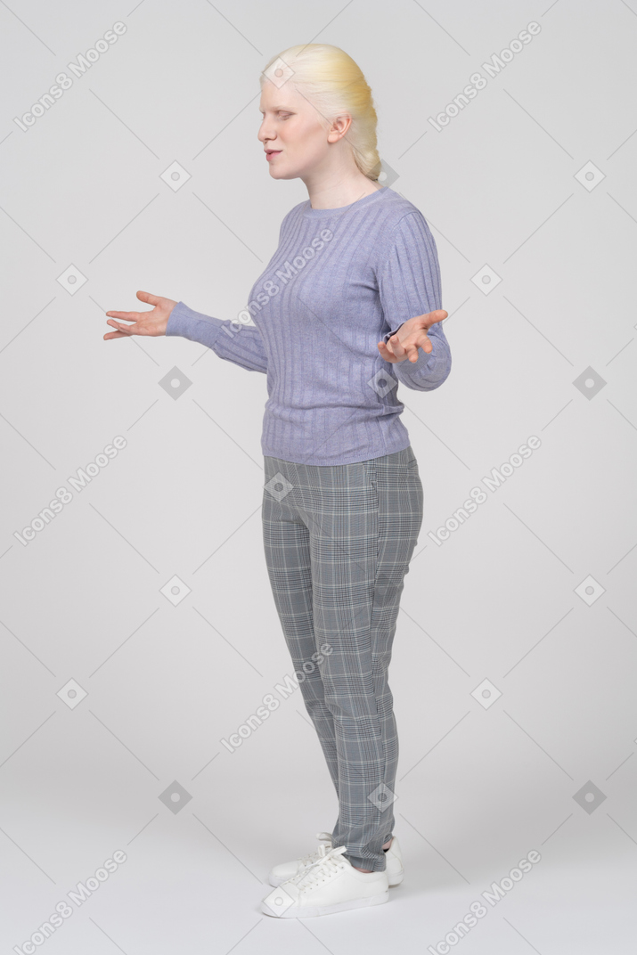 Young woman with eyes closed shrugging