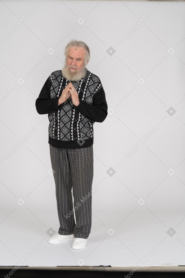 Old man begging with hands folded