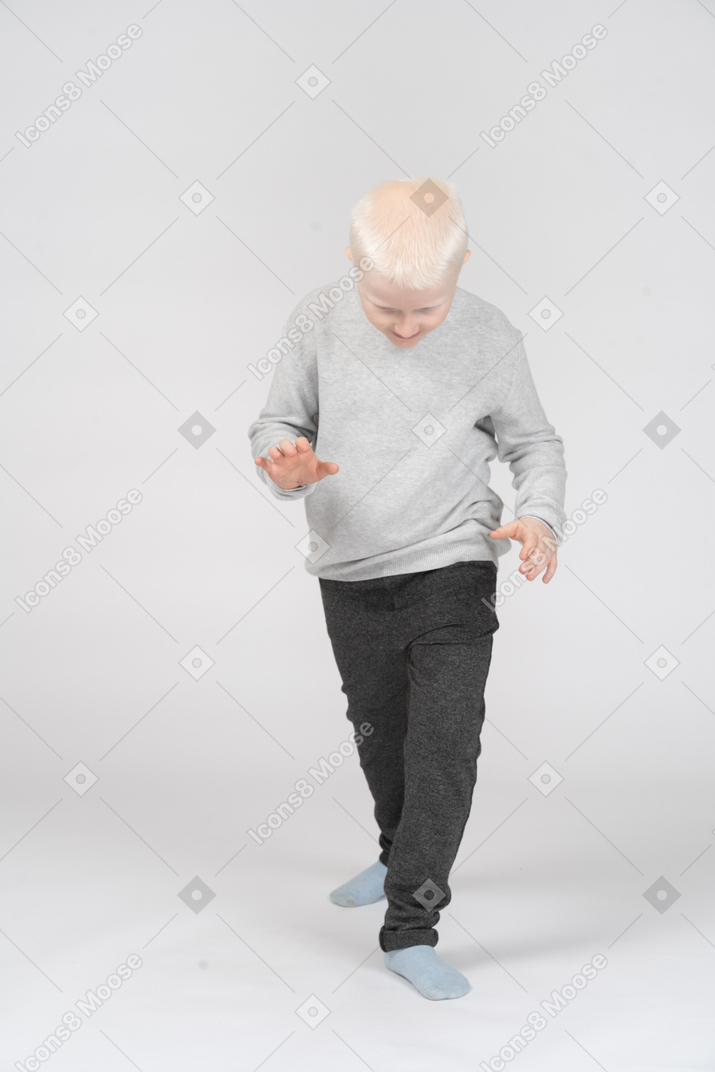 Little boy walking sneakily