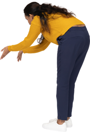 Side view of a girl in casual clothes bending down with extended arms