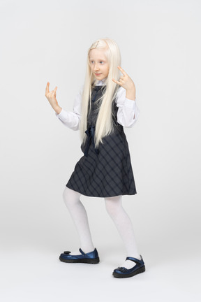 Schoolgirl making metal horns gesture