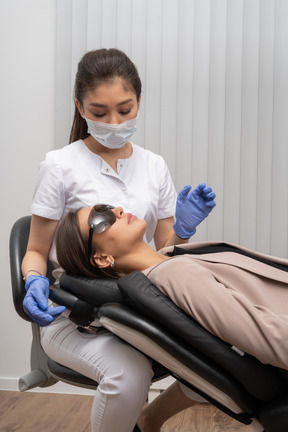 A female dentist examining her female patient