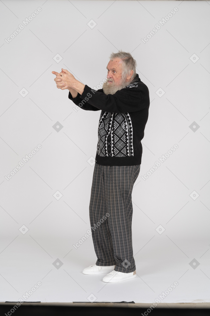 Old man aiming with finger gun