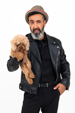 Mature man holding a puppy