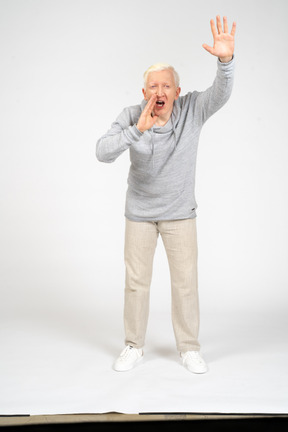 Front view of a man with raised arm screaming