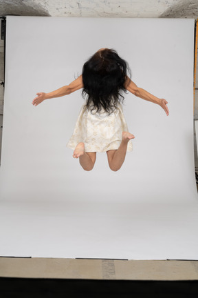 Woman in beautiful dress jumping