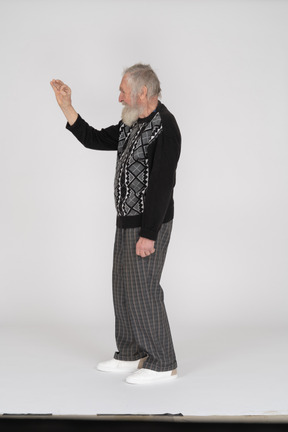 Side view of old man showing ok gesture