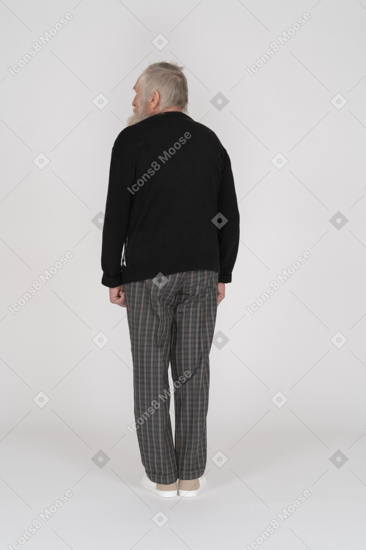 Rear view of old man looking aside with hand turned