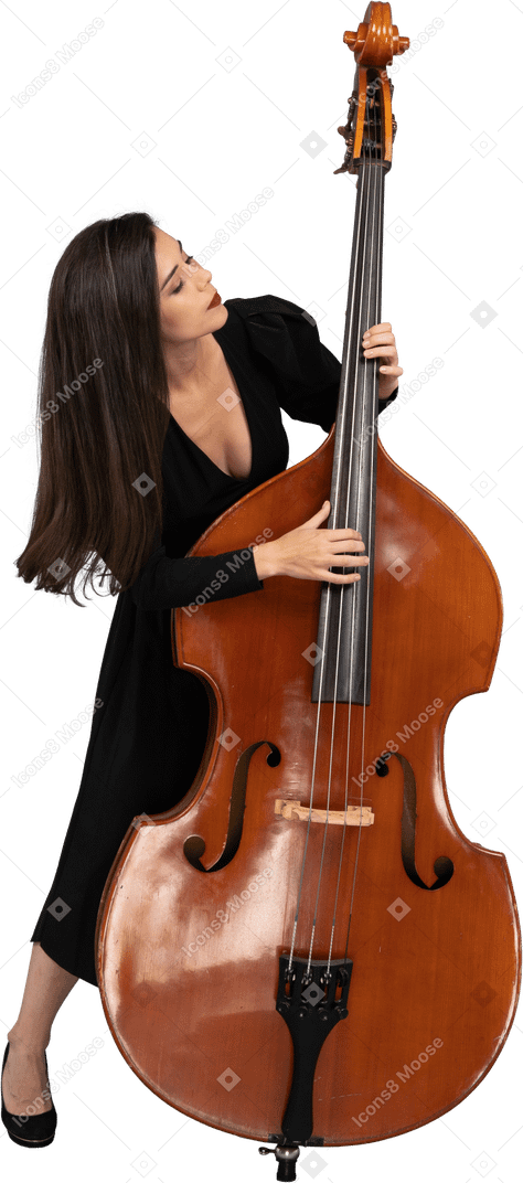 Front view of a young woman in black dress playing the double-bass and leaning forward