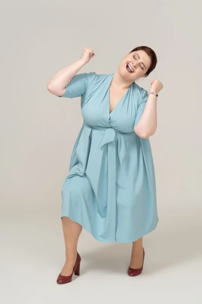 Front view of a happy woman in blue dress