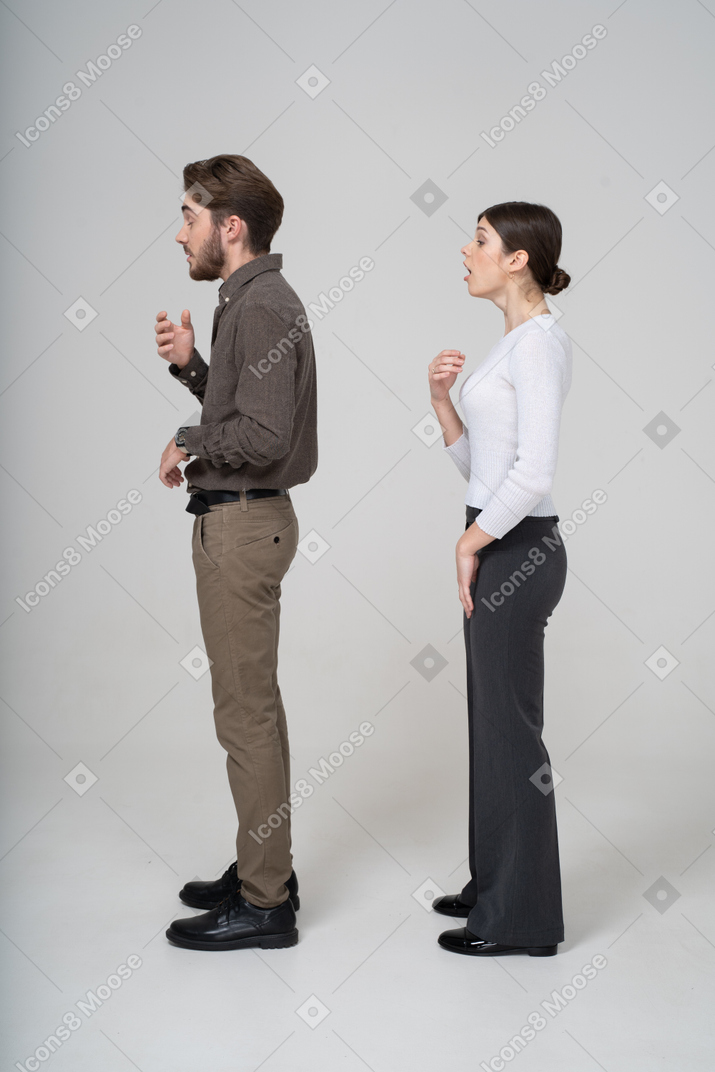 Side view of a sneezing young couple in office clothing
