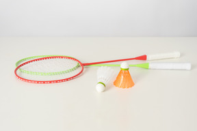 Colorful tennis rackets and shuttlecocks on a white background