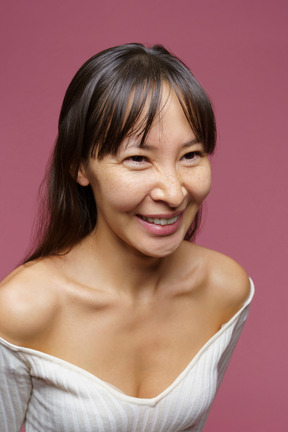 Three-quarter view of a middle-aged woman smiling and looking aside