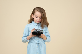 Cute little girl holding a camera