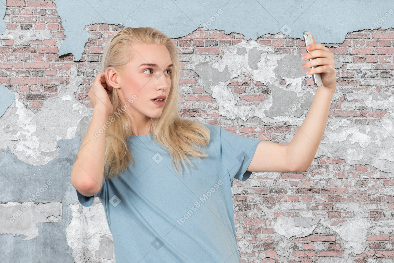 Person taking selfie in front of old wall