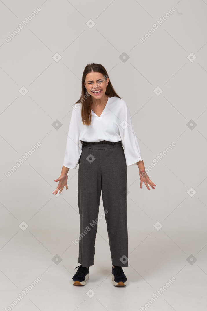 Front view of an emotional young lady in office clothing outspreading hands