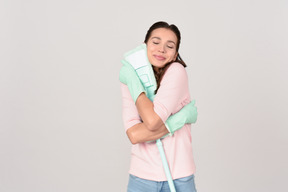 Attractive young woman pleased with her mop