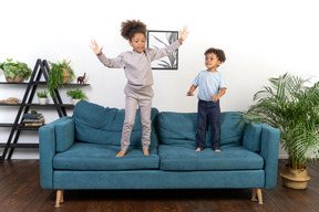 Good looking boy and girl play on the sofa