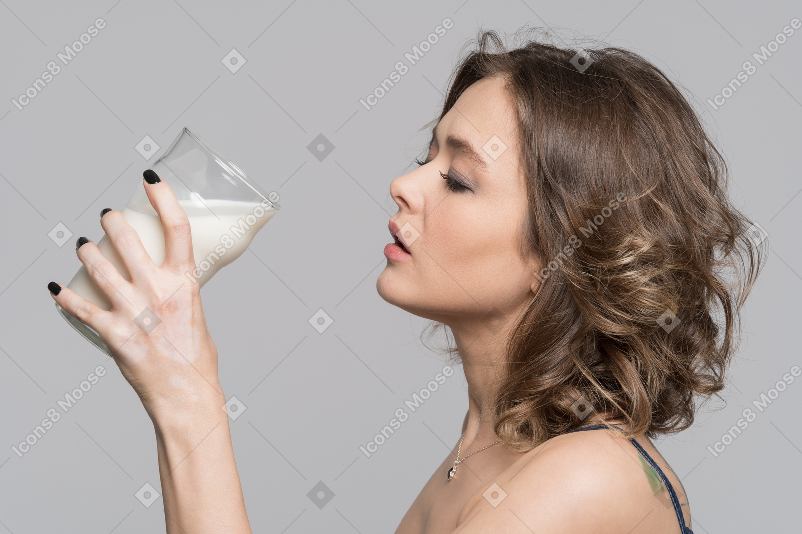 A young woman is about to drink a glass of milk