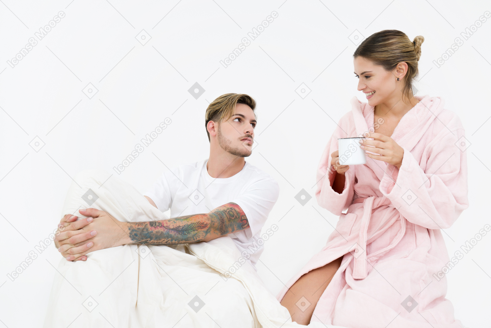 Couple sitting in bed and having coffee