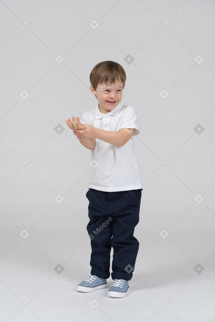 Smiling little boy holding his hand