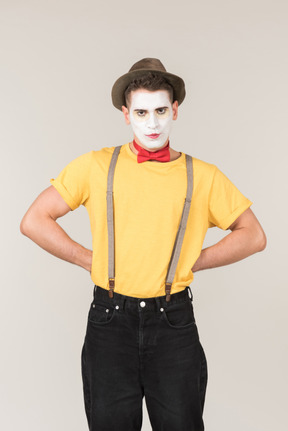 Male clown standing with hands on his hips