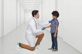 A man in a white lab coat and a little boy in a blue shirt