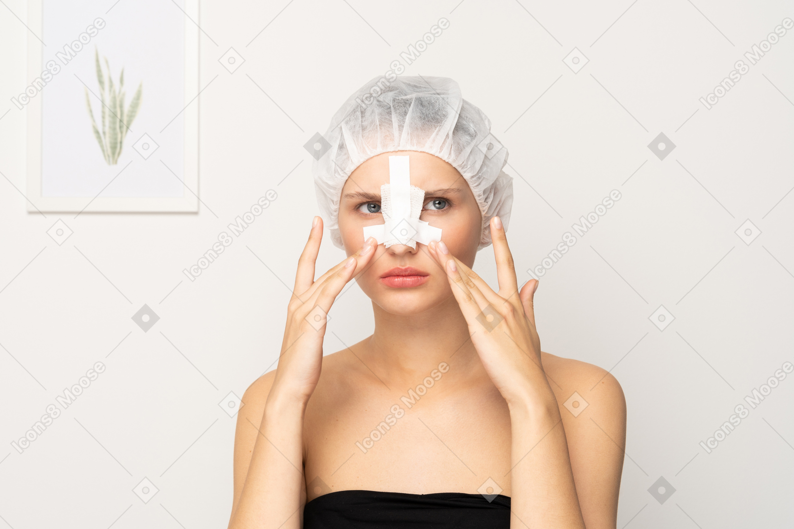 Grumpy young woman with bandaged nose touching her face