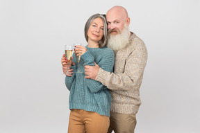 Elegant senior couple drinking champagne