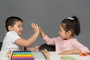 Brother and sister giving each other a high five